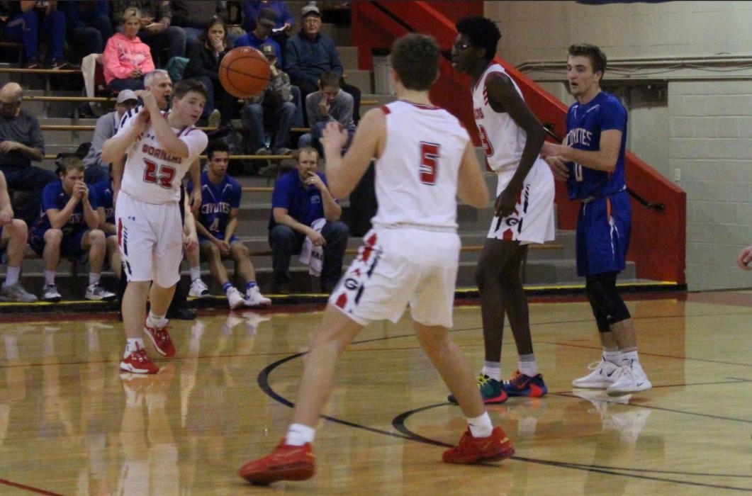 Gorilla sophomore Jaden Graber #22 passes off to eighth grader Rane Kenzy #5 who added six points against Jones Co. Forward Daniel Mitchell collected 62 points and 31 rebounds during the match-ups against Scotland and Jones Co. (Photo by Kristy Ring)