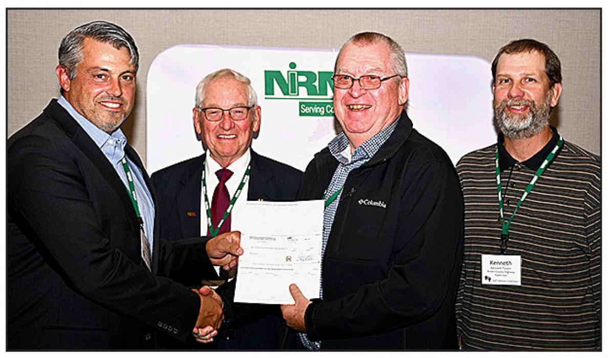 Brown County officials Buddy Small, Bruce Papstein and Kenneth Turpin are shown accepting the county’s financial dividend from NIRMA Board of Directors member Erich Tiemann, a Gage County supervisor.