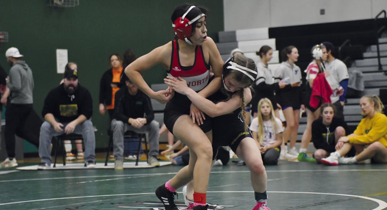 Maya Macias works to get an escape against her opponent at the Elkhorn Vally Invitational.