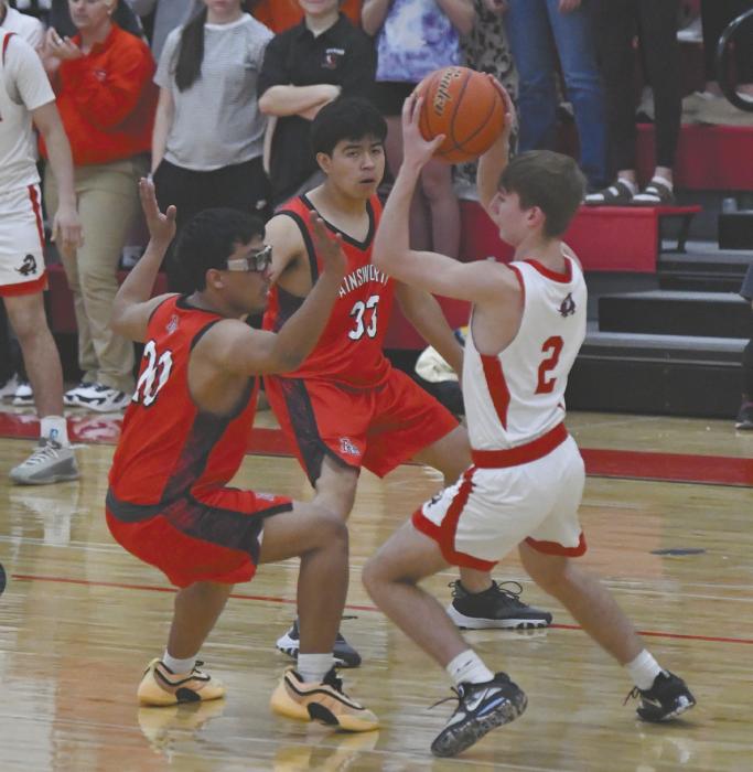 Seniors Adolfo Rojas (20) and Axel Gress (33) play defense on Pender’s Braiden Allvin.