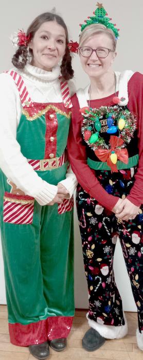 Madonna Coutts (left) won the Ugly Sweater Contest. Coutts and Cheryl Fernau wore some get in the Christmas Spirit Outfits during the Does Christmas Festival.