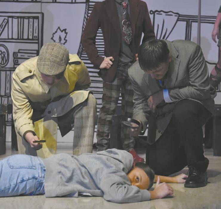 Kristofer Hitchcock (left) and Carson Koch (right) observe the dead body, played by Ava Graff.