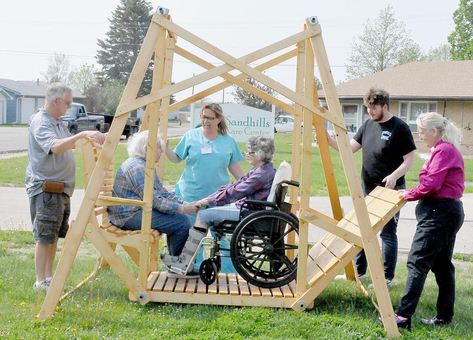 Bringing smiles to residents, Louise Sherman and Dixie Hespe, as they were the first ones to use the newly built and delivered swing set to the Sandhills Care Center on Wednesday, May 24, 2023. Assisting them were Jim Wagner, Michelle Schafer - DON, Phoenix Stich and Penny Jacobs.