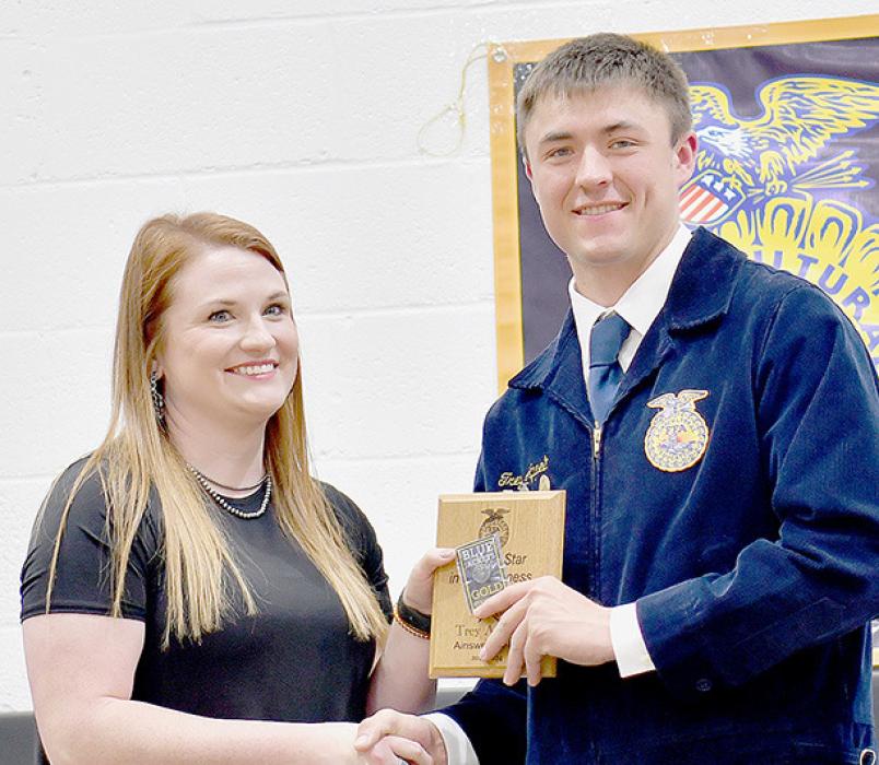 Ainsworth FFA Advisor Emily Jackman (Left) presented the Chapter Star in Agribusiness Award to Trey Appelt (Right).
