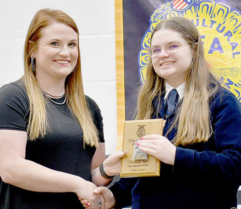 Ainsworth FFA Advisor Emily Jackman (Left) presented the Chapter Star in Agricultural Production Award to Hannah Beel (Right).