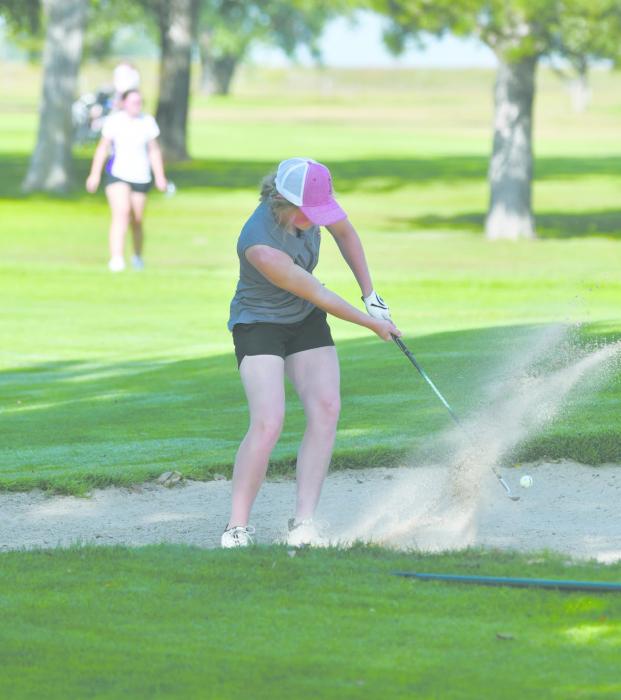 Junior Kenley Welke gets her ball out of the sand trap during the team’s home invite.