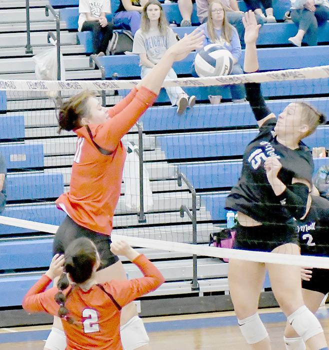 Karli Kral (11) goes up against O’Neill’s Aubrey Jackson (15) for one of her four blocks on the night.