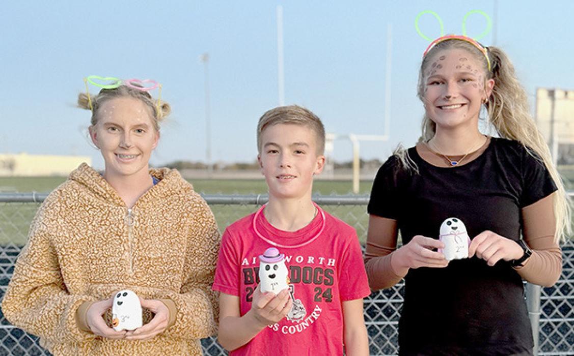 Winners of the Halloween Hustle 5K were (Left to Right) Preselyn Goochey in 3rd place, Blake Hansmeyer in 1st place and Emma Kennedy in 2nd place.