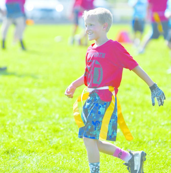 Dax Painter is all smiles after scoring a touchdown during his team’s football game.