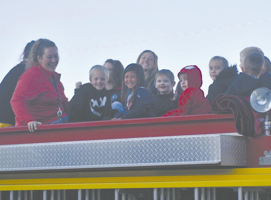 Mrs. Elizabeth Arens’ kindergarten class enjoyed the breeze while they rode around town atop the fire truck.