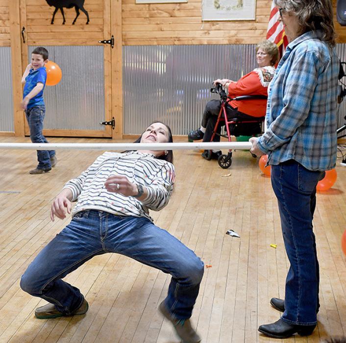 After the sons took their turns at Limbo, the mothers got in line and had their chance. Katie Winters succeeded in her try.