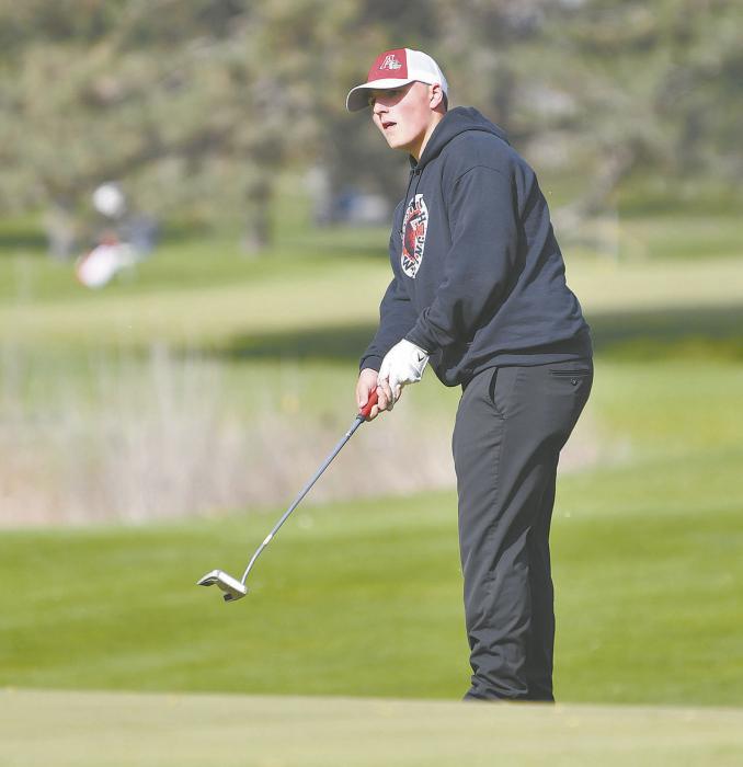 Freshman Carson Koch putts during the invitational.