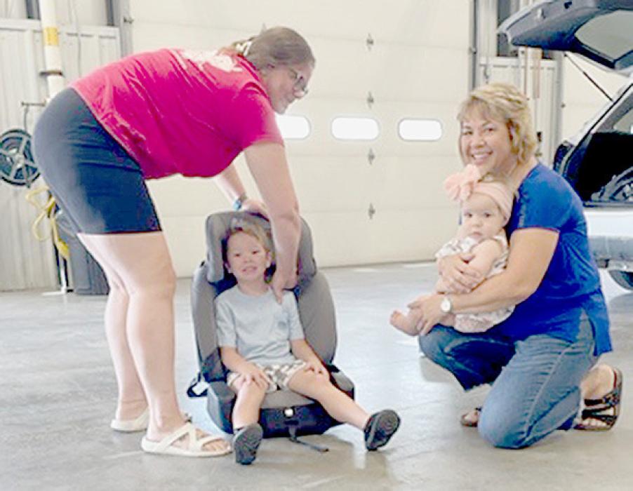 Deb Weiss (right) had the car seats for her two grandchildren checked for proper fit and installation.