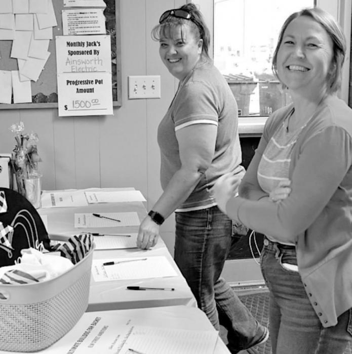 Nancy Steinhauser and Laurie Delimont take some time to make sure their bid was still good on the silent auction items.