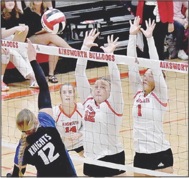 Jocelyn Good and Kendyl Delimont go up for a block against Dayla Dearmont of the North Central Knights.