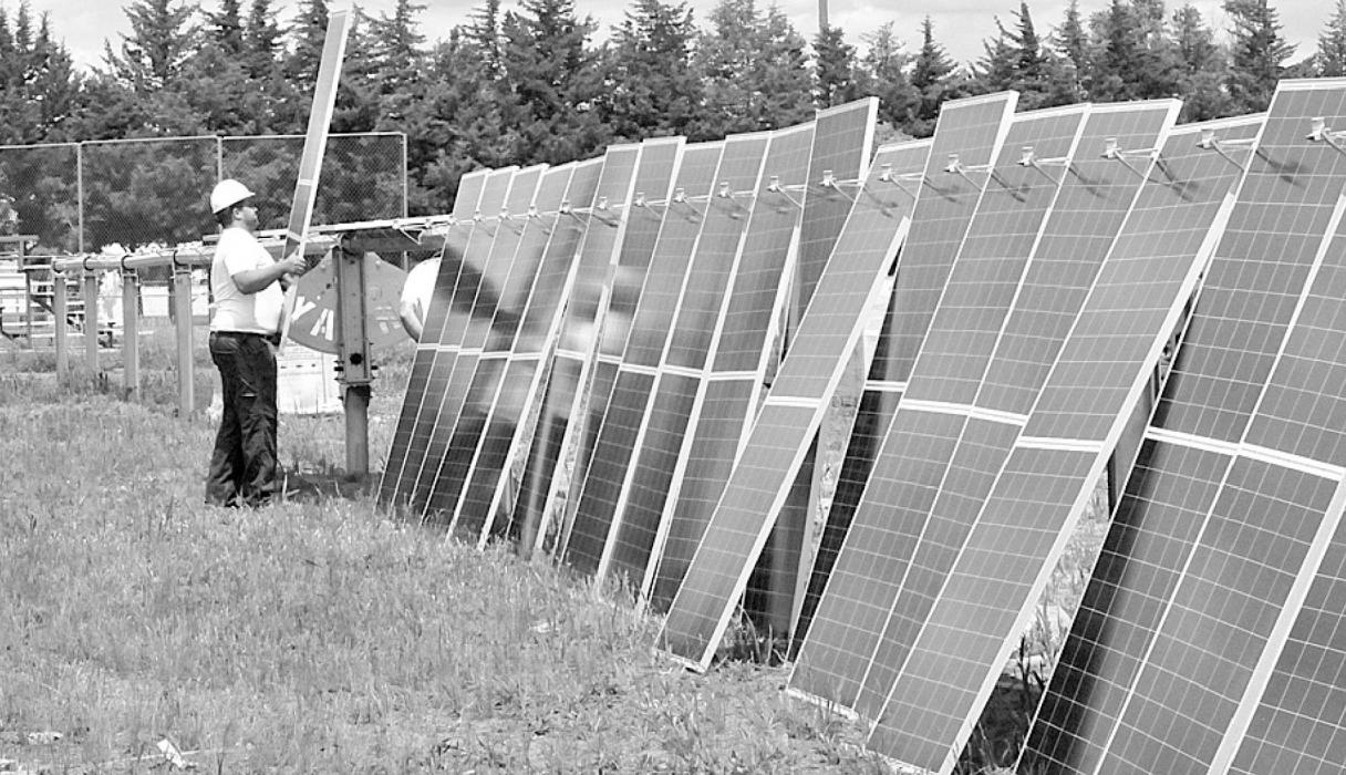 GRNE employees set up a row of solar panels near the ball field located furthest south in East City Park.