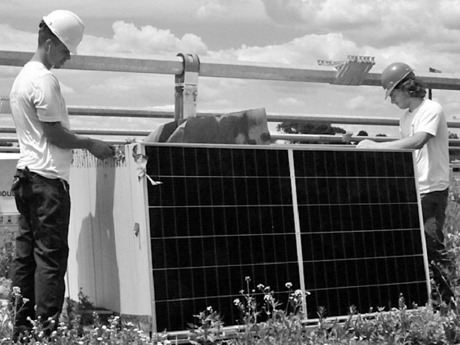 Two GRNE workers unpack a pallet of solar panels. NPPD urges the public to use caution in the vicinity of the construction area.