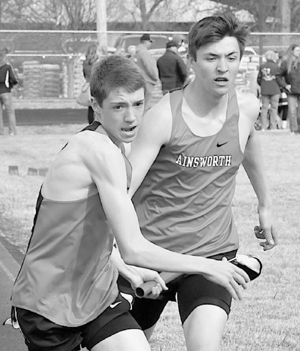 Trey Appelt (right) passes the baton to Ty Schlueter (left) in the Distance Medley. Ainsworth placed fourth in the medley.