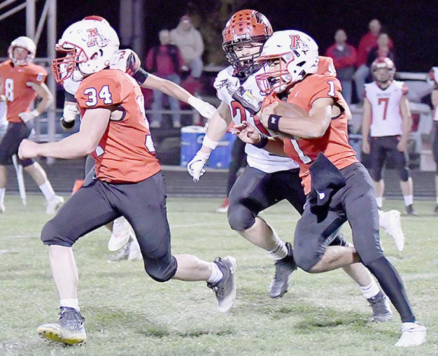 With Jacob Held, #34, leading the way, Chris Fernandez, #1, makes a good gain for Ainsworth. Fernandez rushed for 66 yards and completed 8 of 10 passes for 95 yards and 2 touchdowns.