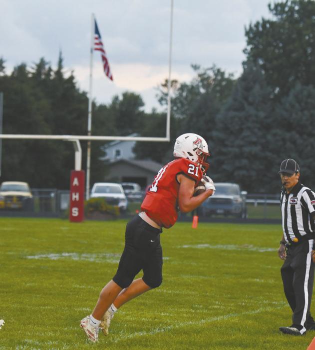 Junior Jaxon Rucker stretches to receive a pass from Bear Rea and manages to keep his feet in bounds as he catches it.