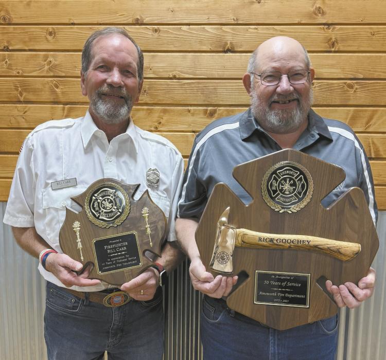 Bill Carr (left) and Rick Goochey (right) were given plaques for their years of dedication to the Ainsworth Fire Department.