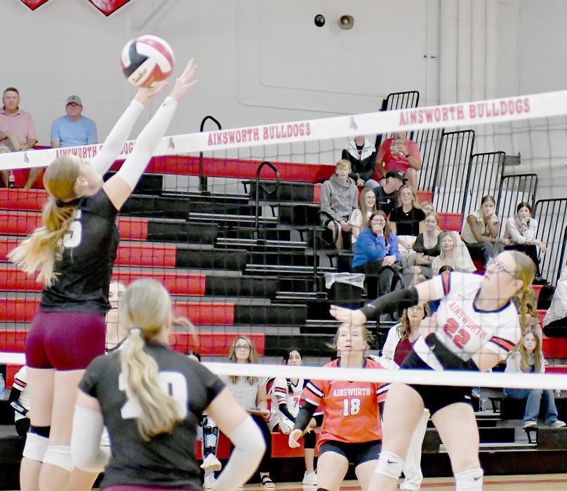 Gracyn Painter sends the volleyball back over to the Stuart Broncos during their match up last week. Lily Beel (18) was ready to assist if the ball came back over.