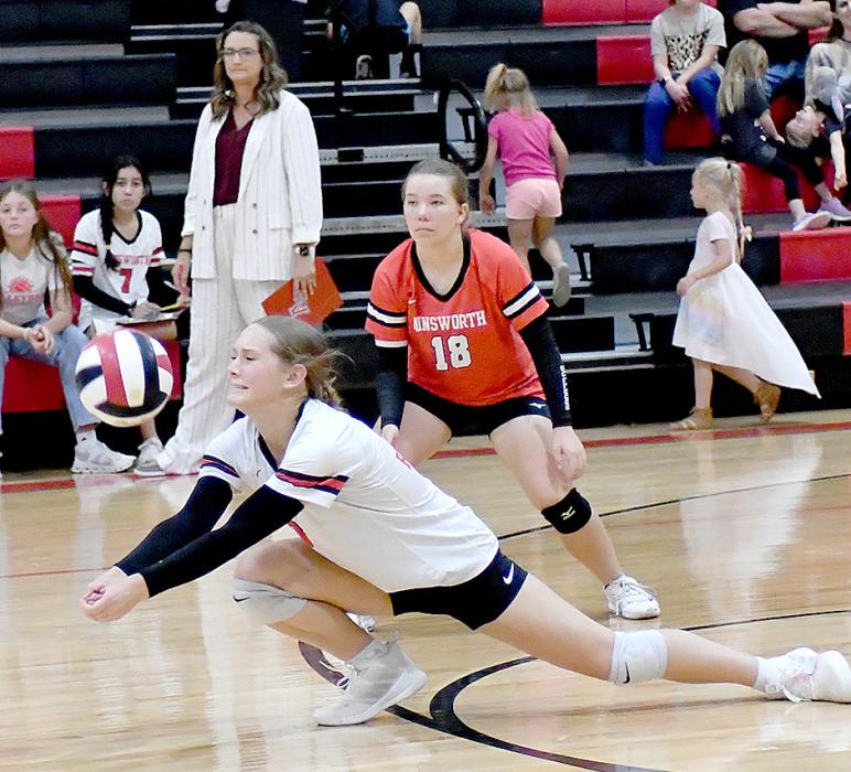 Megan Jones bumps the ball up to her teammates while playing against the North Central Knights. Teammate Lily Beel (18) is ready to help her teammate if need be.