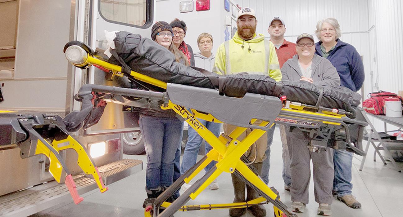 Members of the Thedford Volunteer Rescue Squad stand with the new Stryker Power Load System. Member are (Left to right): Jemma DeNaeyer, Sandy Heavican, Pat Neben, Gordon Needs, Loren Eaton, Brenda Corbin and Shirley Hanna.