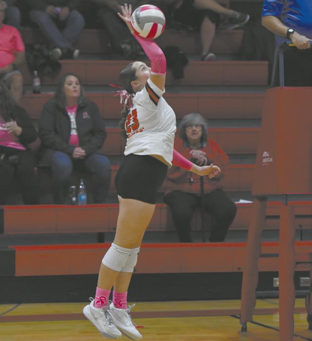 Payton Sears, one of the two freshman varsity starters, attacks a ball during the team’s pink out match against Summerland.