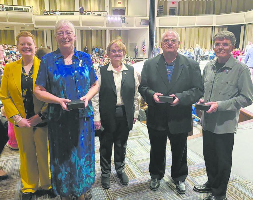 During the 2025 NSAA State Speech competition, Mary Rau was honored for Outstanding Service in the activities of speech and play production. The four recipients are pictured above with NSAA Assistant Director. (left to right): Director Taryn Retzlaff, award recipients Mary Rau, Mariann von Rein, Rick Tank, and Randy Rood.
