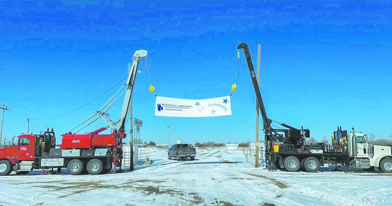 Beck’s Well and Irrigation Trucks hang a banner to commemorate their 75 year-old, multi-generation family business.