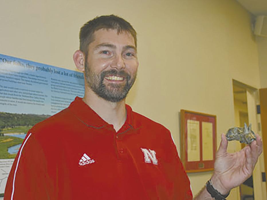 Shane Tucker holds one of his findings at Niobrara NSR at a Fossil Presentation in 2019.