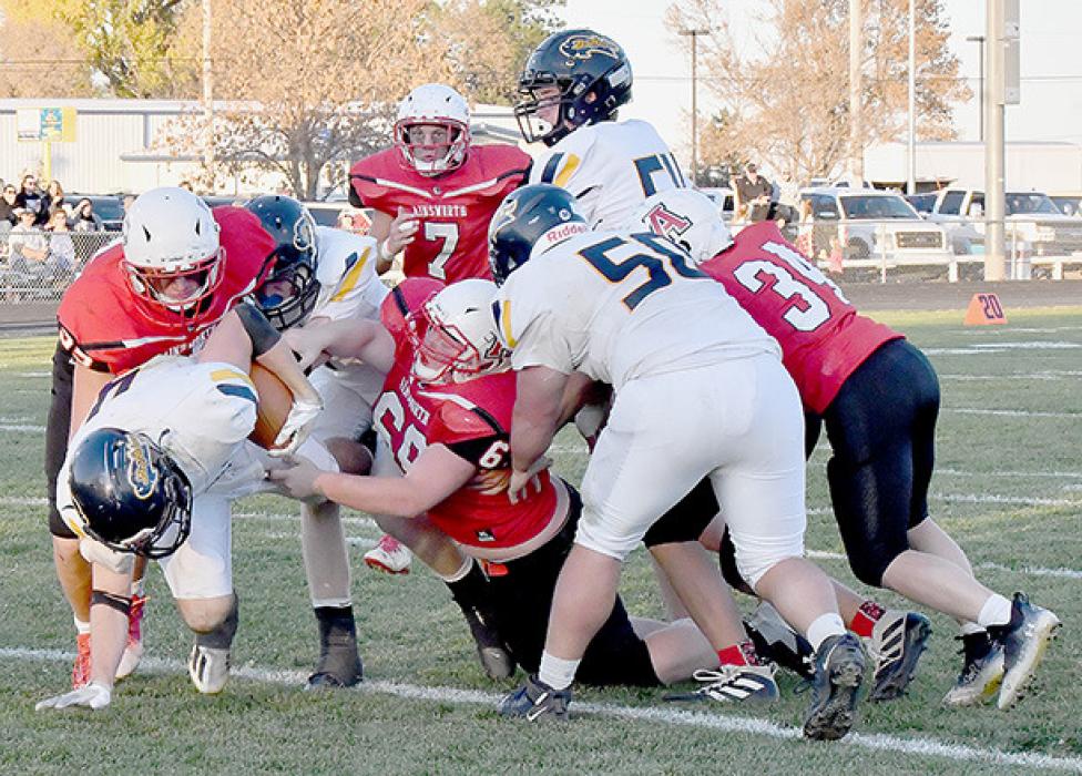 The Elm Creek Buffaloes aggressive running style required two tacklers many times. It took Carter Nelson and Ian Finley to bring down Elm Creek’s Carter Erickson on this play.