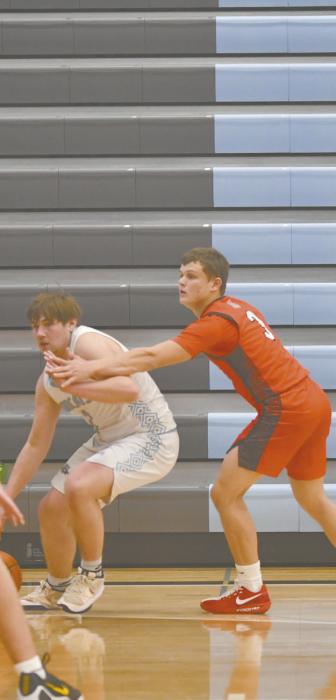 Chris Fernandez finds himself on the ground after being fouled during an attempted fast break layup. Zaine Evans (right) guards Aiden McAllister of Summerland.