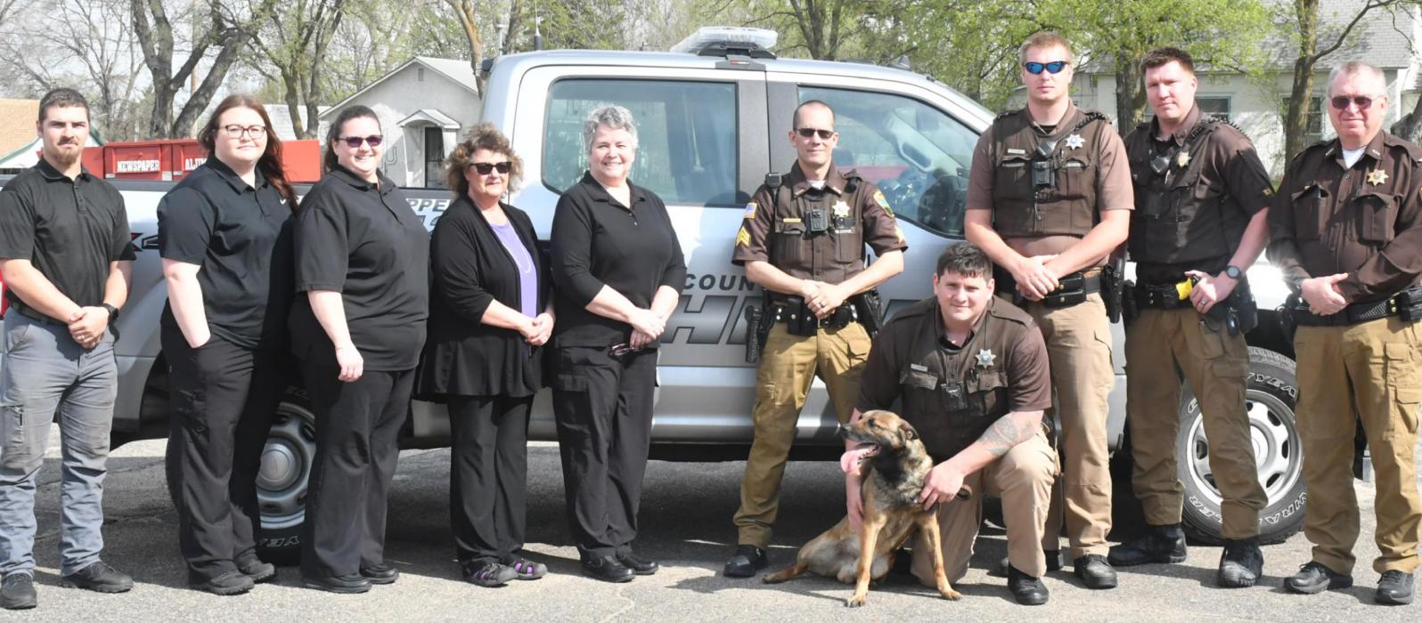 Brown County Sheriff’s Office employees include (left to right): Dispatcher and Correction Officers Cash Boland, Chelsea Grunhaupt, Tanya Cole and Tami Gum and Dispatcher &amp; Matron Lori Ganser, Sergeant BJ Nilson, K9 Dutch, K9 Deputy Ian Calder, Deputy Kyle Stang, Chief Deputy Zach Welch and Sheriff Bruce Papstein.