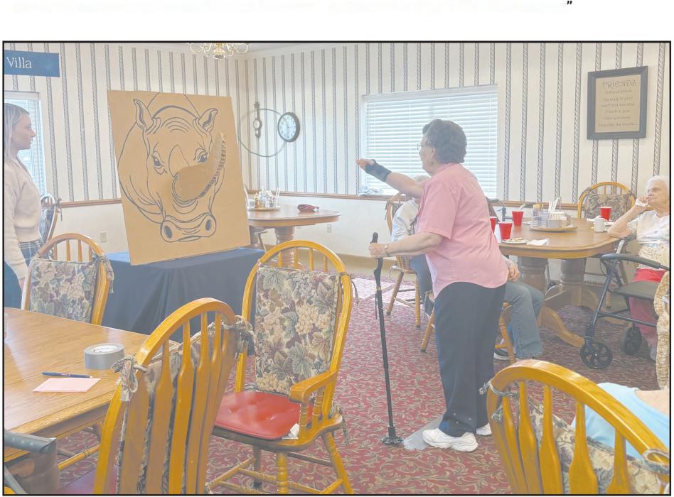 On Friday, Cottonwood Villa held a party full of snacks and games. Pictured above is a resident playing the Rhino Horn Ring Toss game.