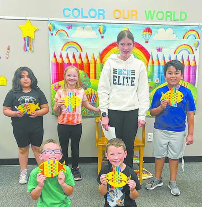 Summer readers show off their colorful fish projects.