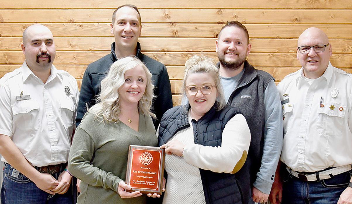 Red & White Grocery was named Business of the Year by the Ainsworth Fire &amp; Rescue. Bryce and Erica Hasenohr and Joe and Meggie Mashburn accepted the award for Red &amp; White Market. Pictured are (Back Row - Left to Right): Ainsworth Fire &amp; Rescue President Heath Rudnick, Bryce Hasenohr, Joe Mashburn, Fire Chief Brad Fiala; (Front Row - Left to Right): Erica Hasenohr and Meggie Mashburn.