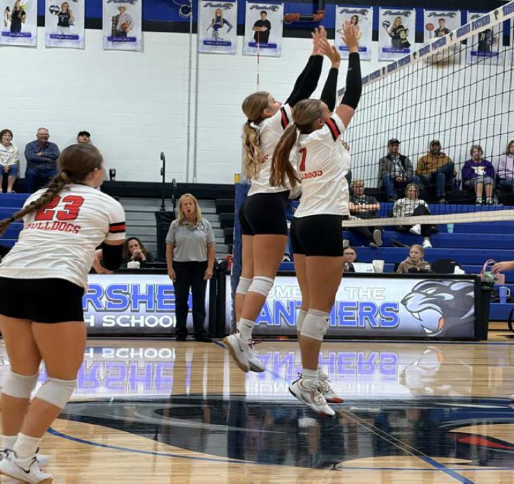 Jaylee Good and Ava Graff (7) attempt to block a hit during the Hershey Tournament. Payton Sears (23) prepares to cover in case the ball drops.