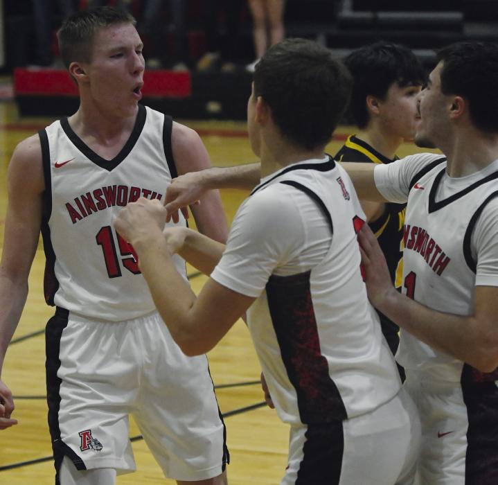 Ainsworth sophomore Jacob Ortner (left) celebrates with teammates Zaine Evans (center) and Chris Fernandez (right) after making a two-point shot with two seconds remaining in the game for the Bulldogs to take the lead against Mullen. See more statistics and photos from the boys basketball team’s recent games on page five of this week’s issue.