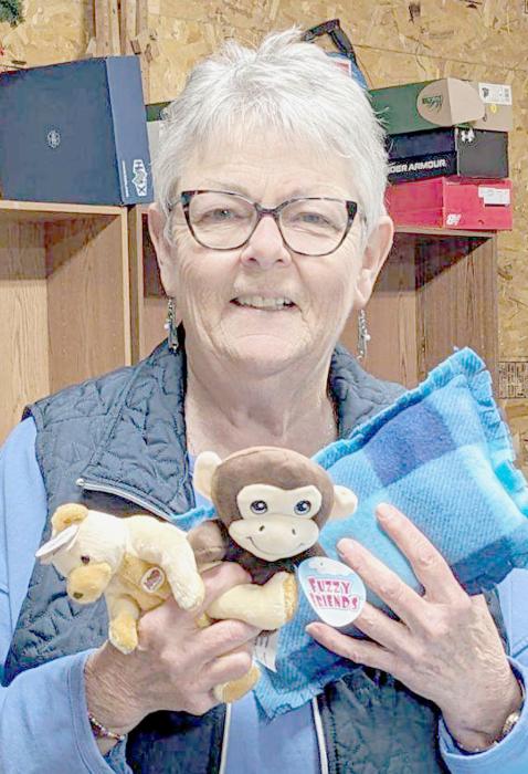 Konny Saner, the Shoebox Team Leader, shows some of the Beanie Babies and pillows that went into the shoeboxes.