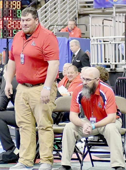 Landon Holloway puts a spin move on Ryan Woitaszewski of Wisner-Pilger in first round action at the State Wrestling Tournament. Head Coach Blaine Finney and Assistant Coach Cody Stutzman watch as Landon Holloway wins his match against John Leija (Right Photo).