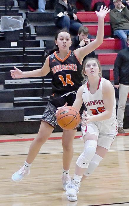 Saylen Young drives past CWC’s Annabel Waldo and is looking for a shot in Ainsworth’s 74-41 win.