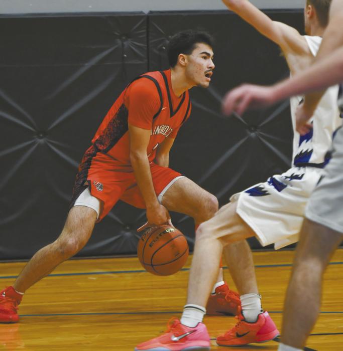 Senior Chris Fernandez dribbles between his legs to try and escape the Knights defense.