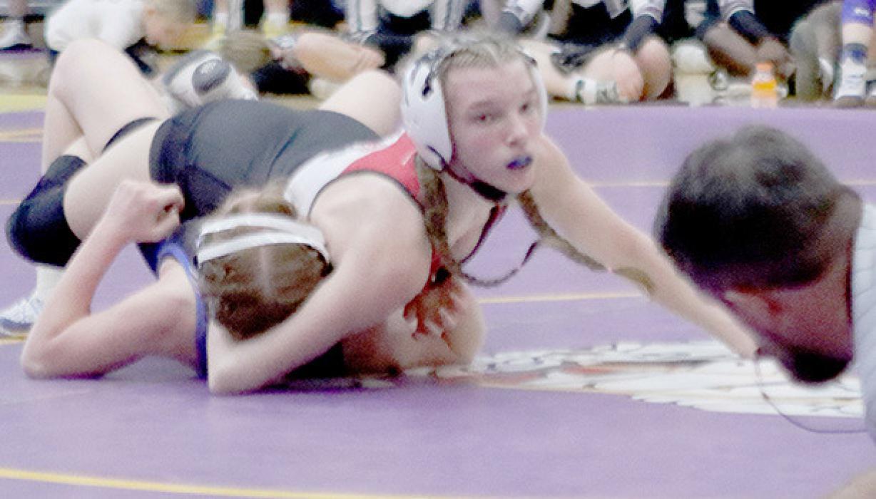 Jolyn Pozehl looks for the pin call from the ref. Pozehl was crowned District Champ in the 115 lb. weight class and will compete at the NSAA State Wrestling Tournament.