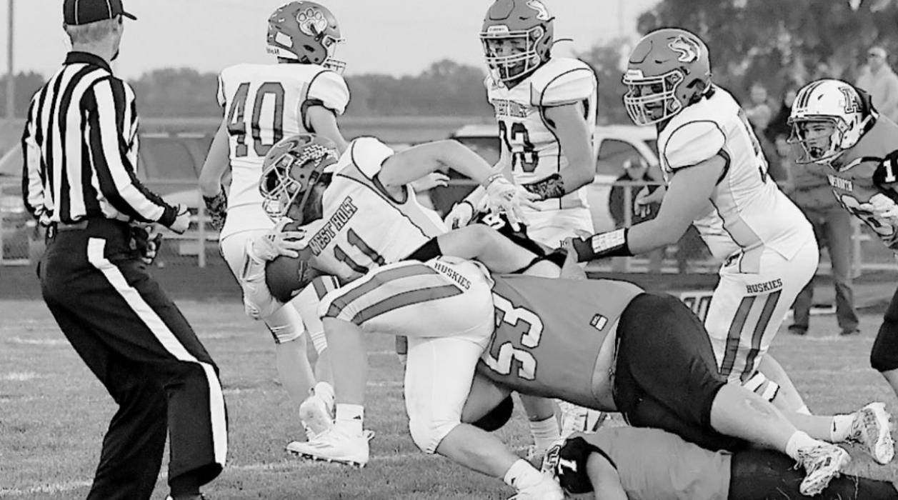 Gabe Allen goes over Ainsworth’s Landon Holloway to bring down Caid McCart of Neligh-Oakdale.
