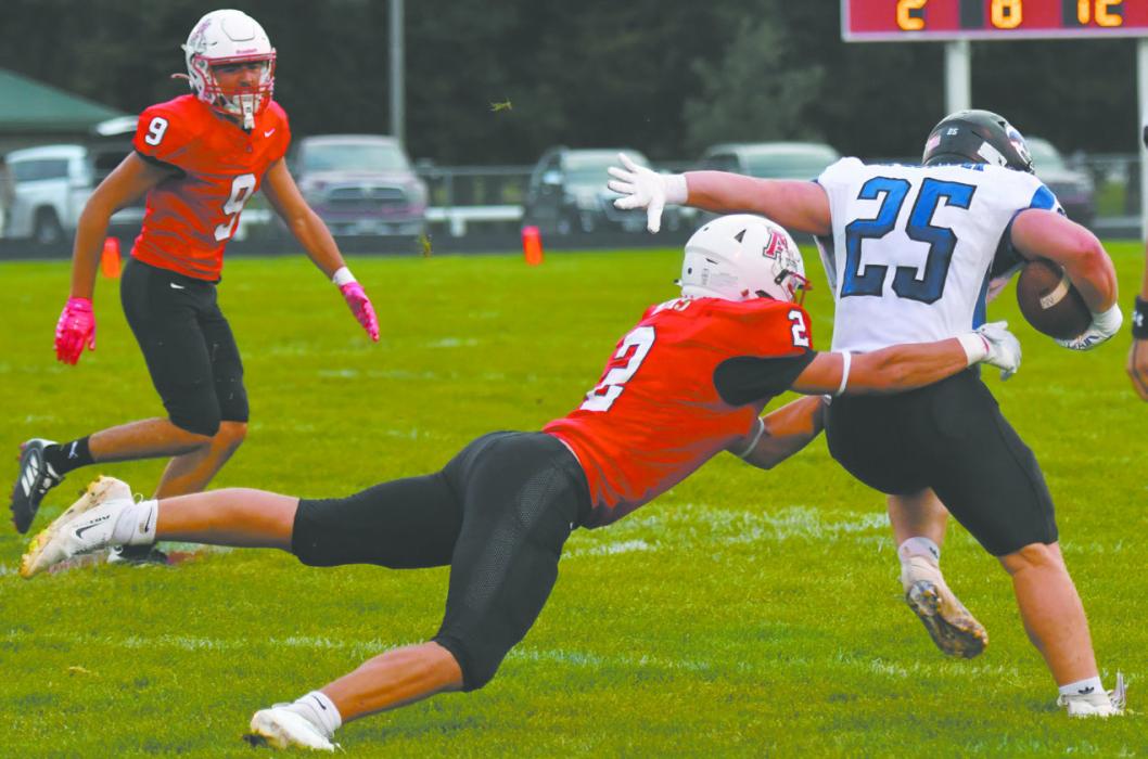Zaine Evans (2) lunges after Niobrara/Verdigre's Jacob Motacek (25) during the team's recent home game. Evans led the team with 14 total tackles, nine of which were solo, and one for loss.