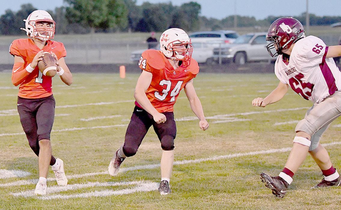 Jacob Held, #34, helped give Chris Fernandez, #1, plenty of time to pass. Fernandez completed 19 of 23 passes for 228 yards and three touchdowns.