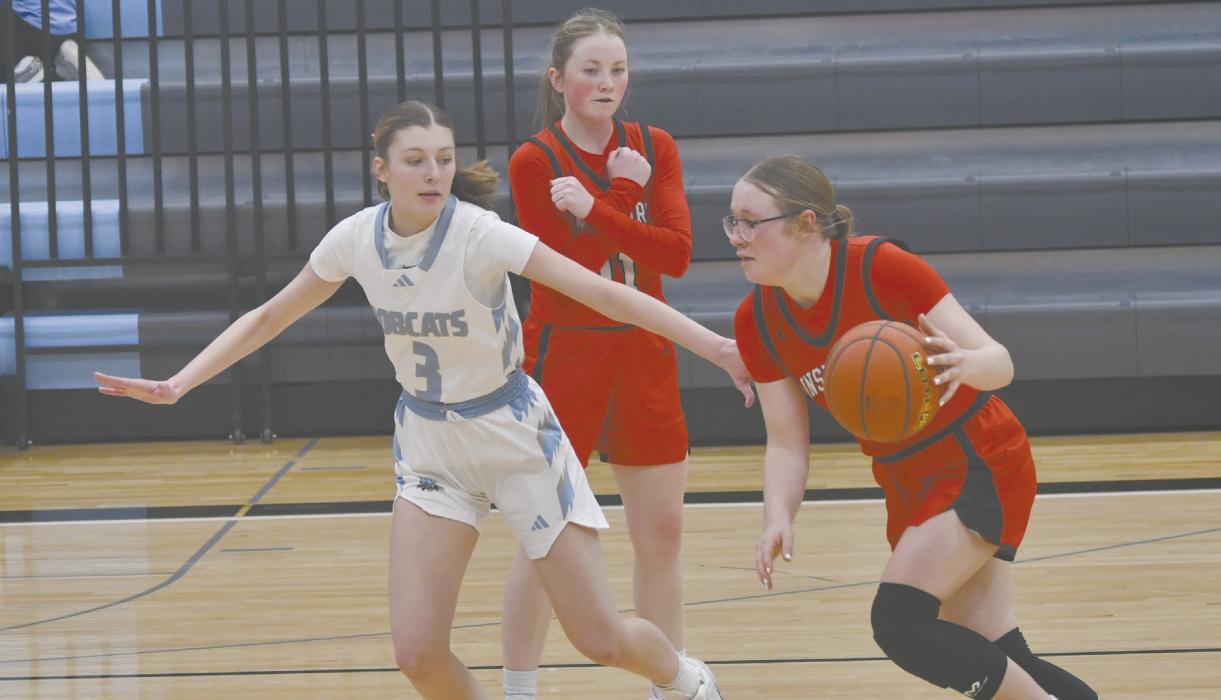 Gracyn Painter (right) dribbles around Abryelle Kester of Summerland as Kenley Welke sets a screen.
