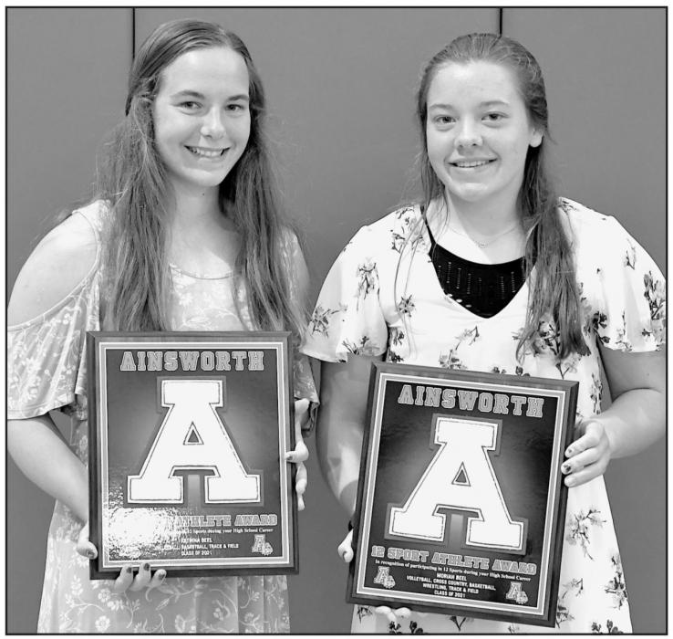 Two senior athletes received plaques for participating in at least three sports each year during their four years at Ainsworth High School: Katrina Beel (left) and Moriah Beel (right).